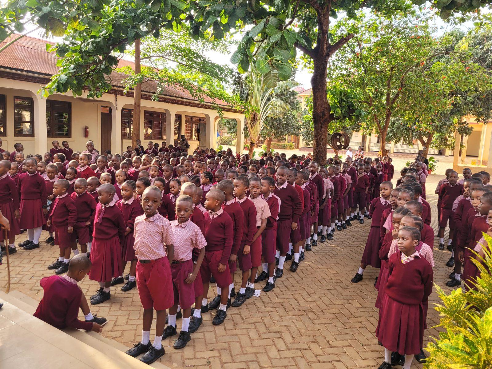 Bensal pupils in burgundy uniform lined up together in the school compound