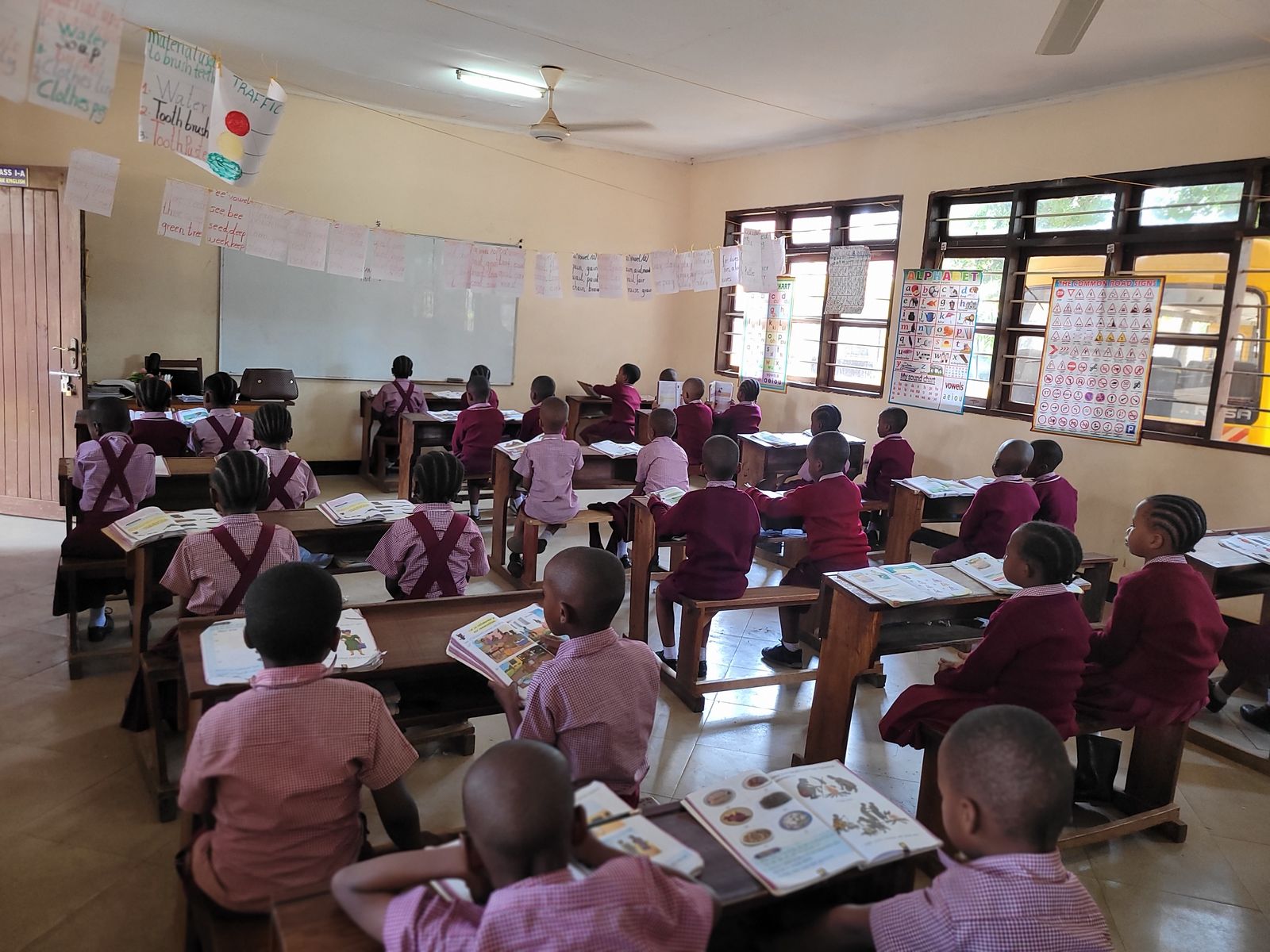 Primary pupils with their books open in class
